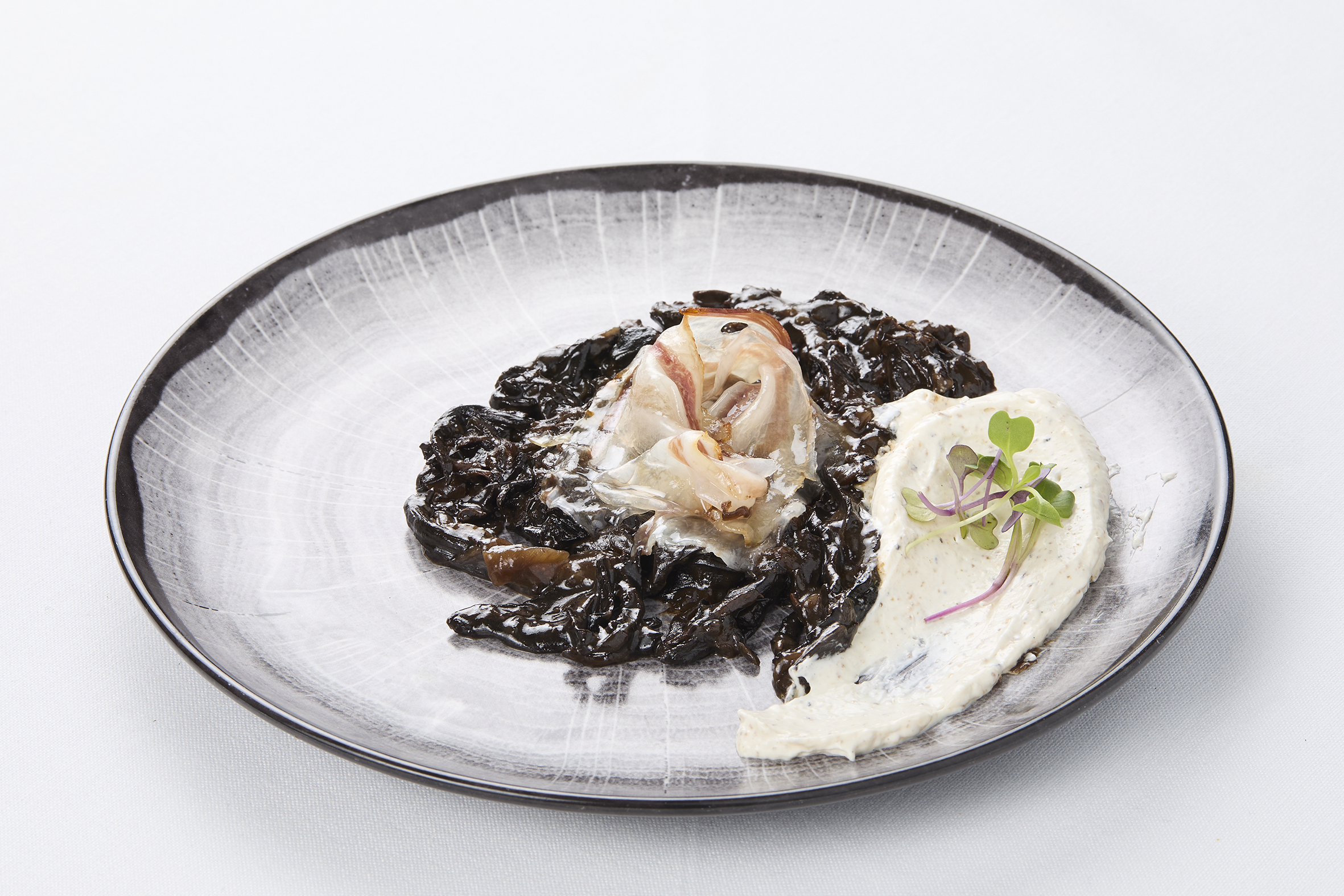 Trompetas de la muerte, guisadas con vino sanson, acompañadas con crema de queso de cabra trufado y velo de tocino ibérico. Restaurante Casa Masip, Ezcaray (La Rioja), Spain.